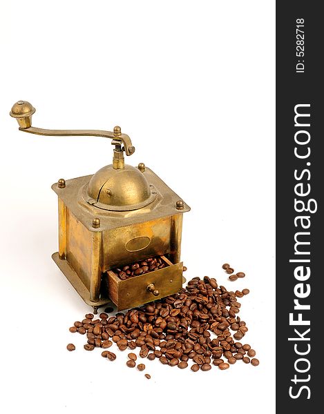 Antiquity coffee machine with beans over white