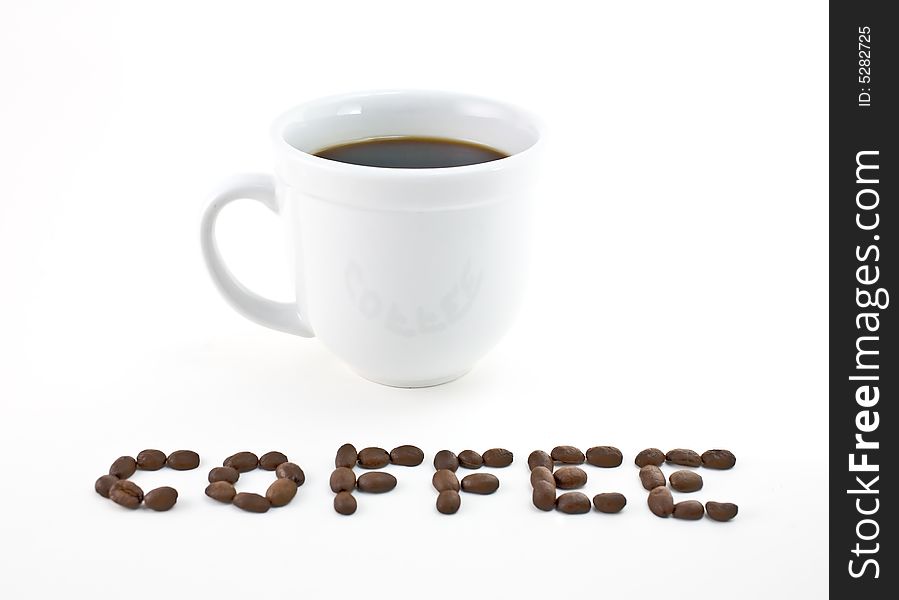 Coffee cup with the word coffee spelled out in beans.
