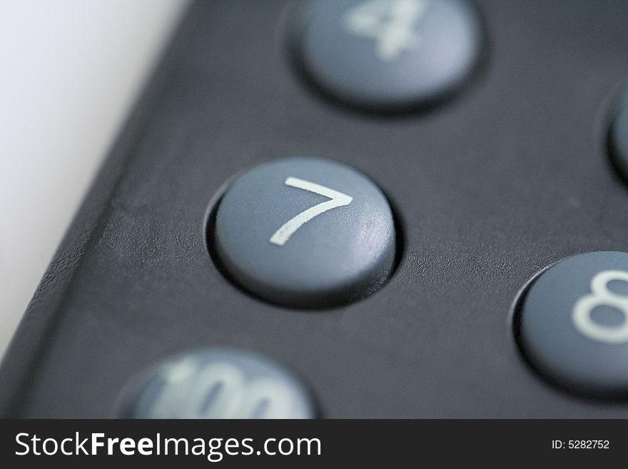A close up of a number seven button on a remote control