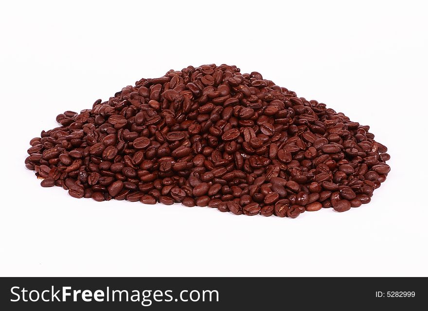 A pile of coffee beans isolated on a white background. A pile of coffee beans isolated on a white background.