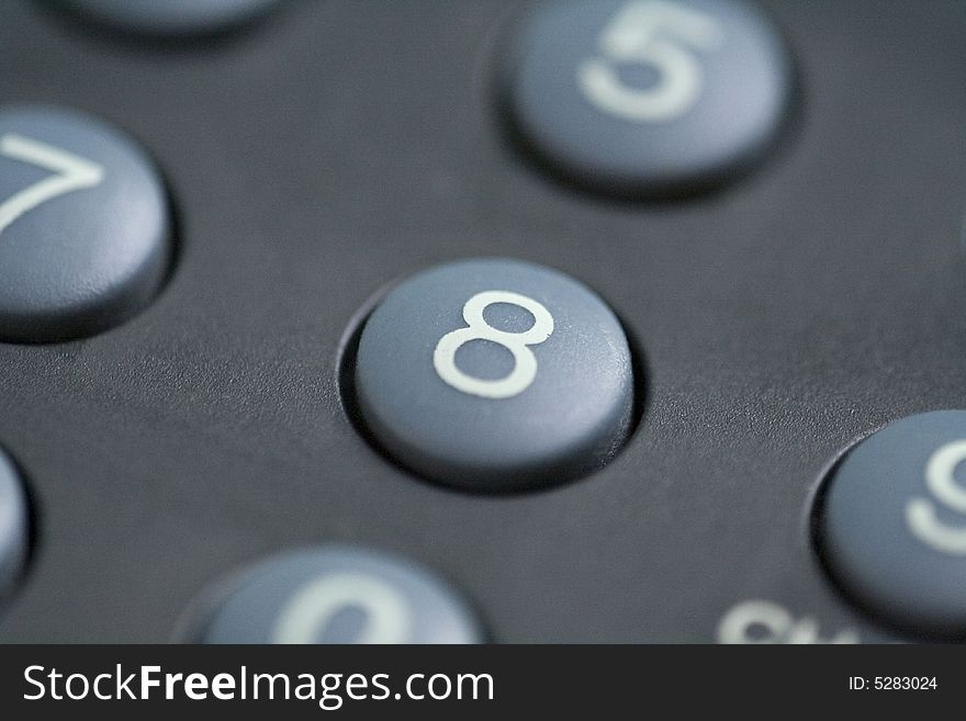 A close up of a number eight button on a remote control