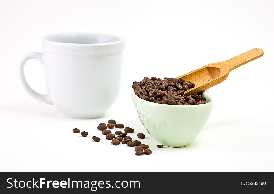 Studio shot of coffee cup, coffee beans with scoop. Studio shot of coffee cup, coffee beans with scoop