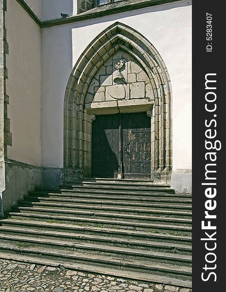 Old staircase and a gate to church