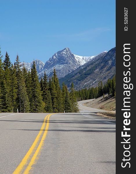 View of mountain peak and winding highway in kananaskis county, alberta, canada. View of mountain peak and winding highway in kananaskis county, alberta, canada