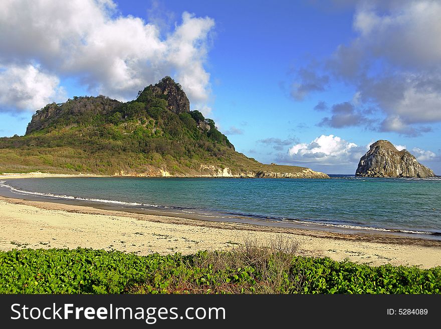 Tropical beach bay with a small island near the coast. Tropical beach bay with a small island near the coast