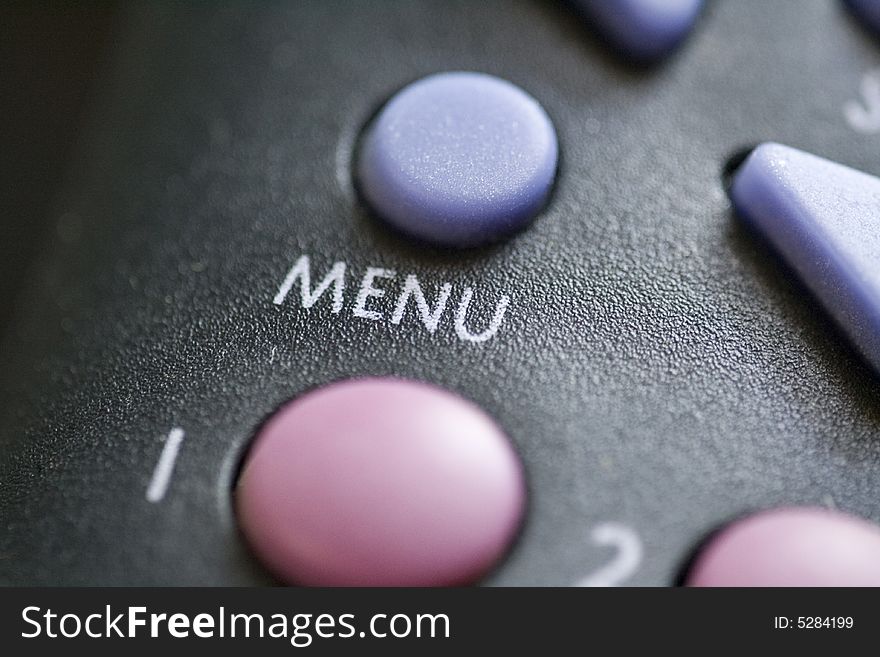 A close up of a menu button on a remote control