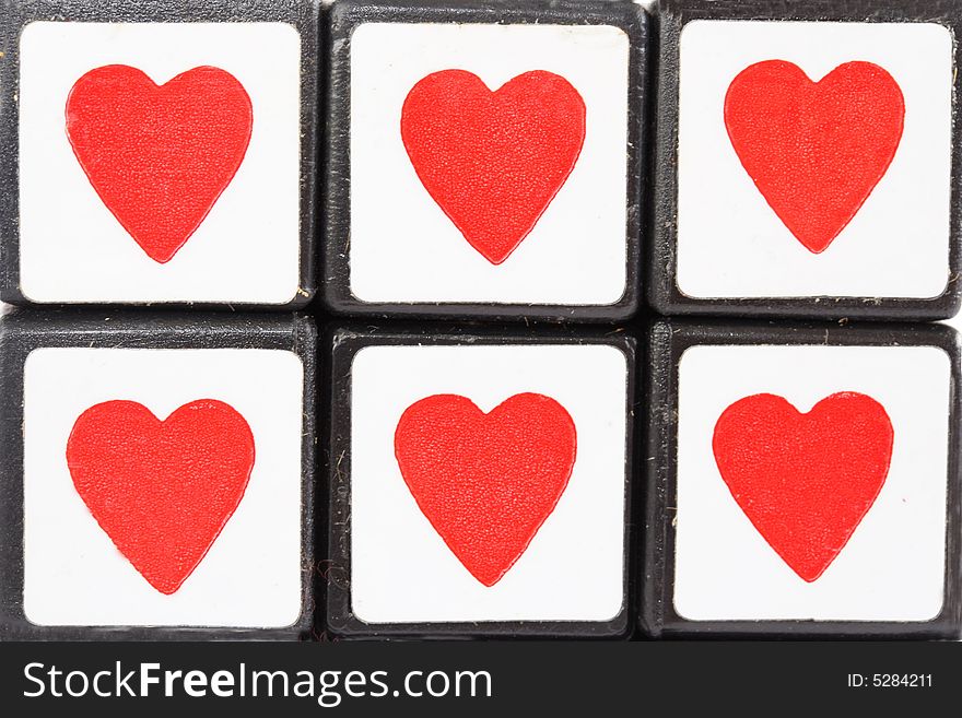 Face of red hearts in a puzzle cube