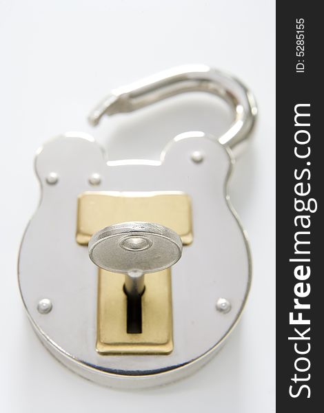 Unlocked padlock with key on white background