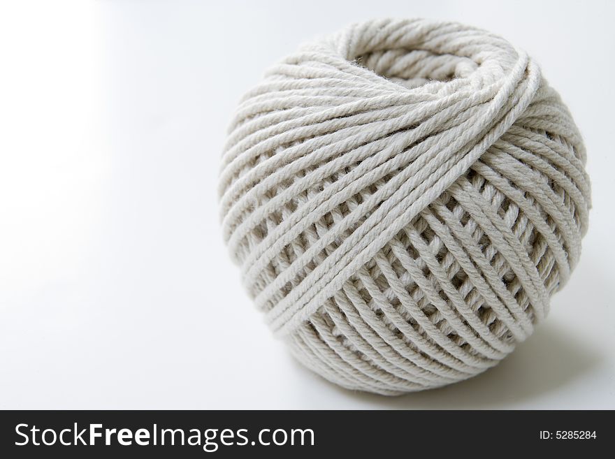 Ball of string on a white background with room for copy