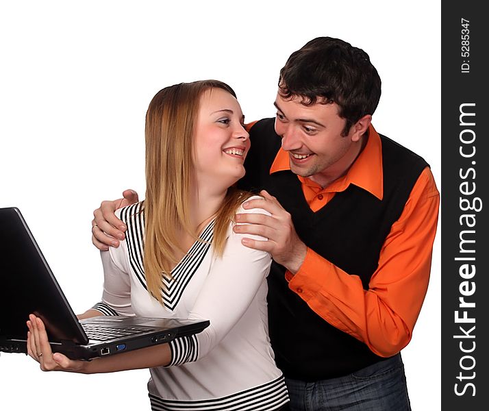 Couple having fun with laptop, pretty blonde and handsome young dark haired man. Couple having fun with laptop, pretty blonde and handsome young dark haired man