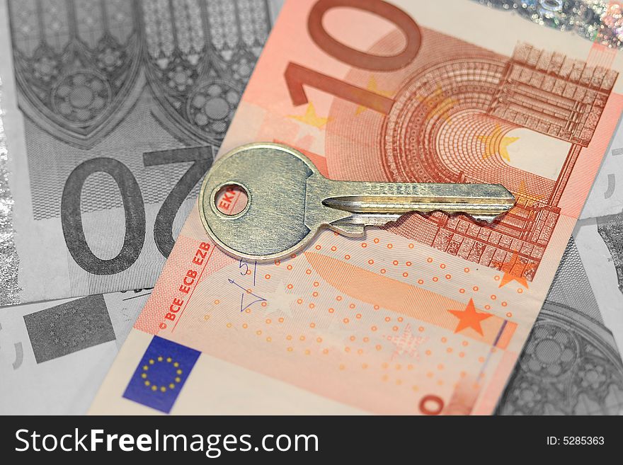 Key, lying on ten euro. The rest of money are desaturated. Key, lying on ten euro. The rest of money are desaturated.