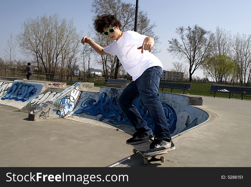 Skateboarder Doing Trick On Ramp