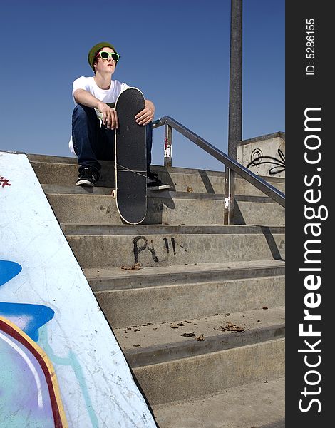 Skateboarder Sitting On Stairs