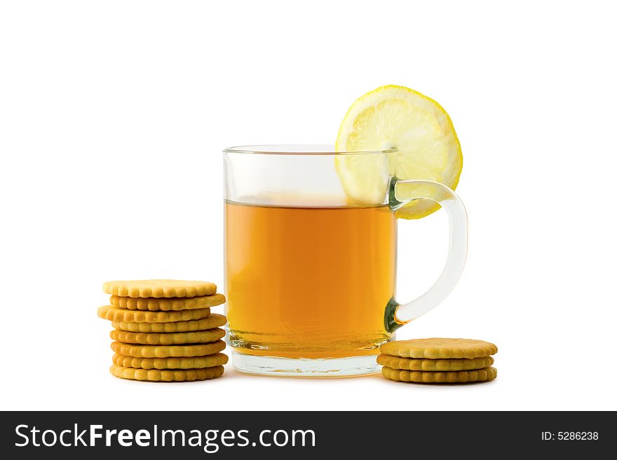 A cup of hot tea with a slice of lemon and crackers over white background. A cup of hot tea with a slice of lemon and crackers over white background