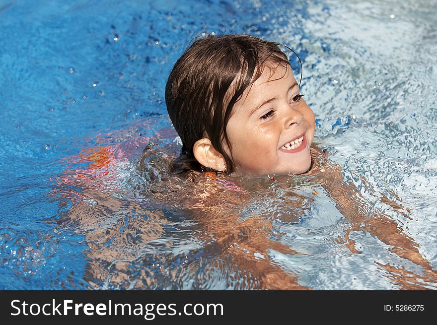 A cute little girl in pool water during the summer. A cute little girl in pool water during the summer