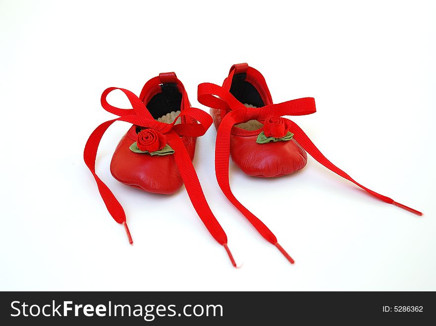 Red shoes with tied ribbon for baby girl and infant. Red shoes with tied ribbon for baby girl and infant.