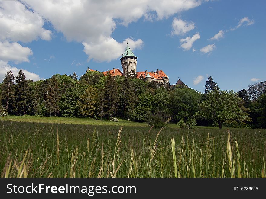 View on a romantic castle in a spring landscape. View on a romantic castle in a spring landscape