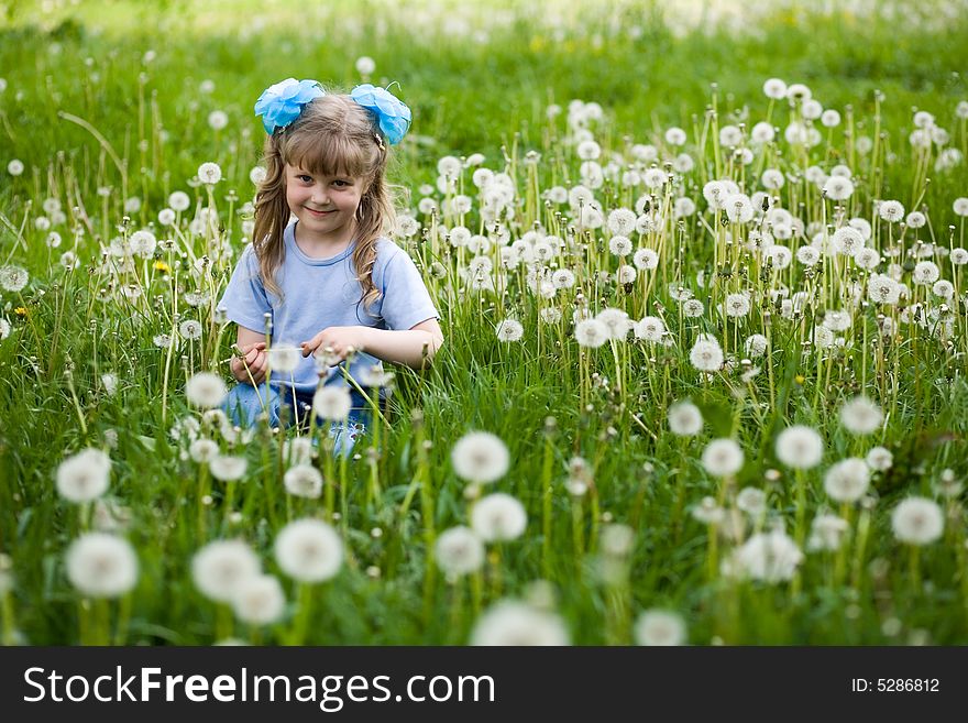 An image of a girl amongst dandelions