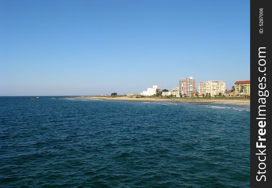 View of city, flats and beach over the sea. View of city, flats and beach over the sea
