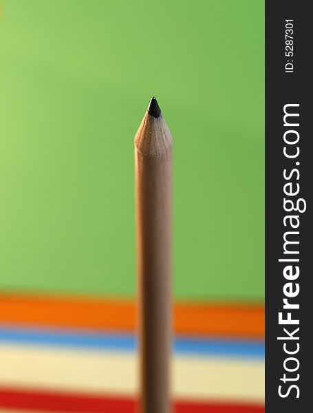 A pencil  with a simple  color background. A pencil  with a simple  color background