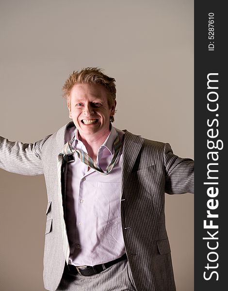 Studio portrait of a middle aged man looking very happy with a loose tie. Studio portrait of a middle aged man looking very happy with a loose tie.