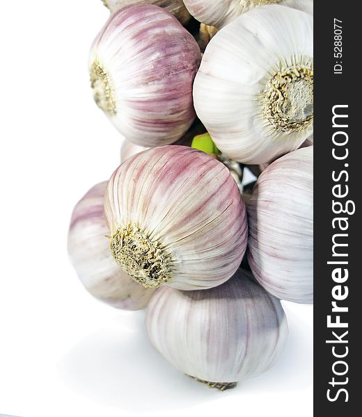 Bunch of garlic heads on a vertical position, isolated on a white background. Bunch of garlic heads on a vertical position, isolated on a white background.