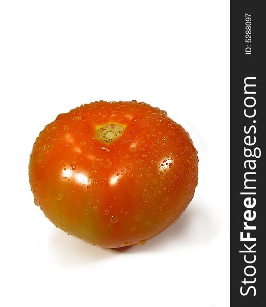 Isolated tomatoe on a white background with droplets of water.