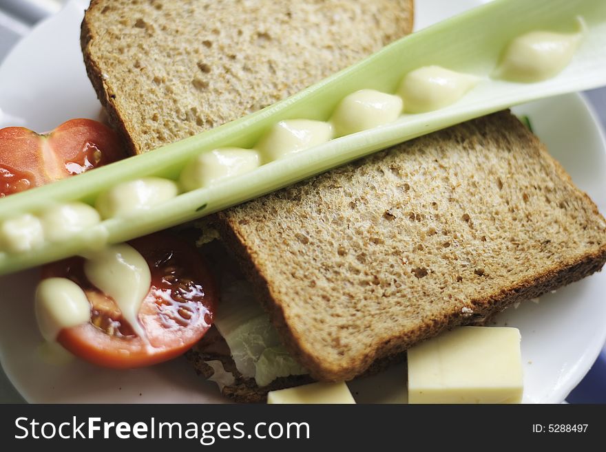 Wholemeal salad sandwich with cucumber lettuce and tomatoes plus celery