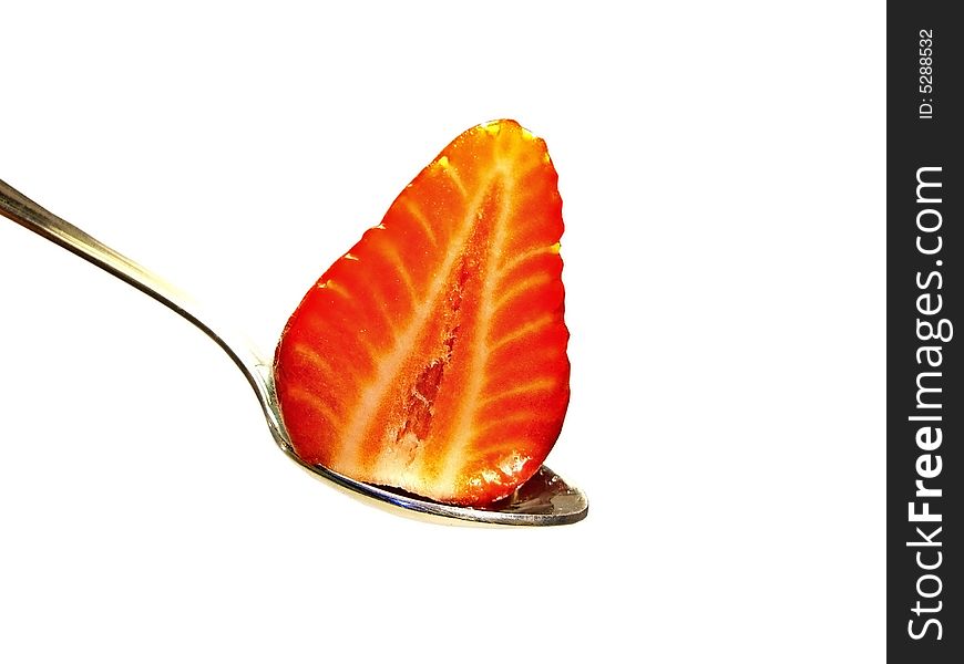 Strawberry sliced in half on top of a spoon on a white background. Strawberry sliced in half on top of a spoon on a white background.