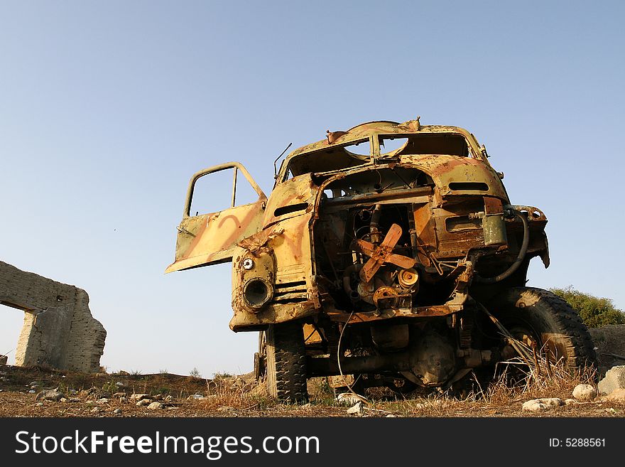 An old wreckage military car in a field