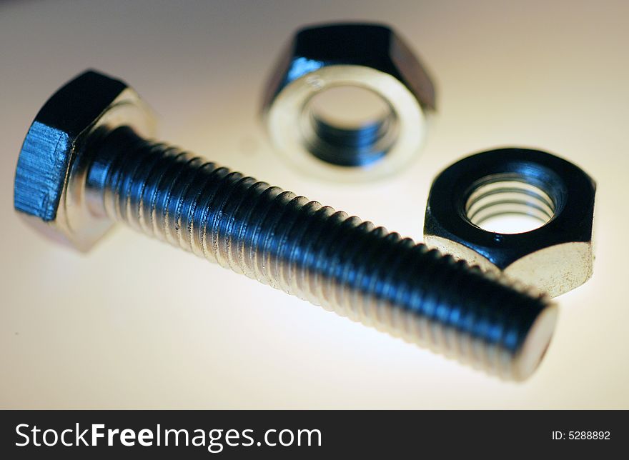 A back lit close up photograph of a hex head screw. A back lit close up photograph of a hex head screw