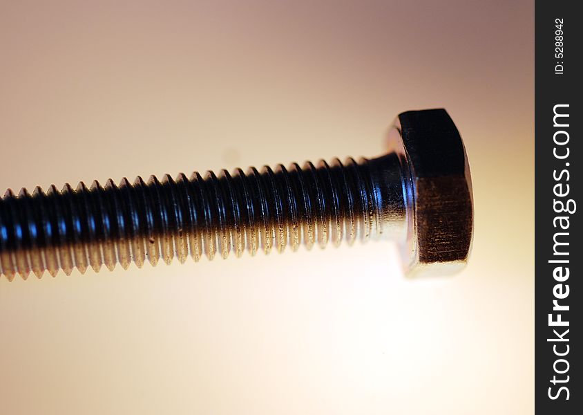 A macro photograph of a hex head screw. A macro photograph of a hex head screw