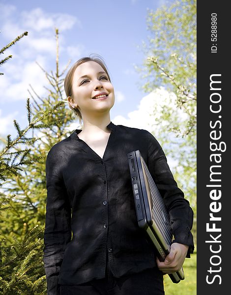 Happy Student. Young Woman With Laptop On Nature Background.