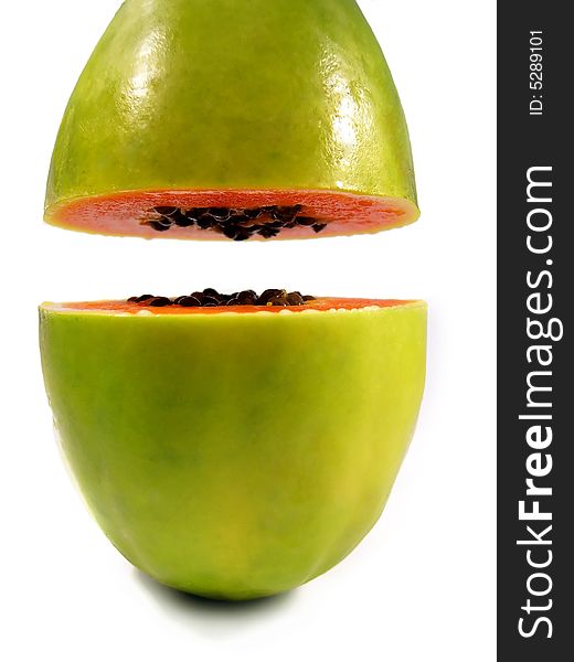 Papaya fruit on a vertical position sliced on half isolated on a white background. Papaya fruit on a vertical position sliced on half isolated on a white background.
