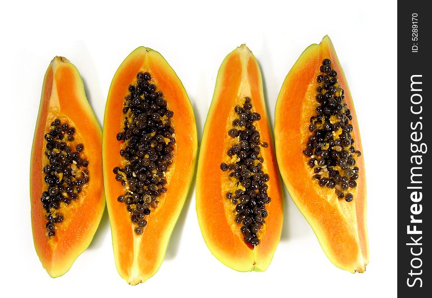 Bunch of papaya fruit slices viewed from the top isolated on a white background. Bunch of papaya fruit slices viewed from the top isolated on a white background.