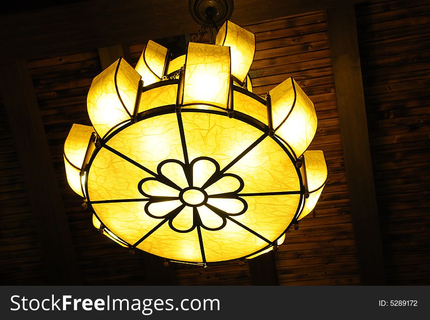 A flower shaped pendant lamp in a restaurant. A flower shaped pendant lamp in a restaurant.