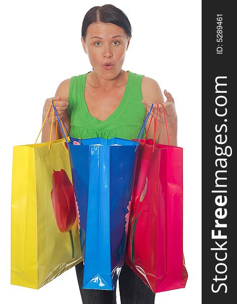 Attractive brunette woman with shopping bags on white background