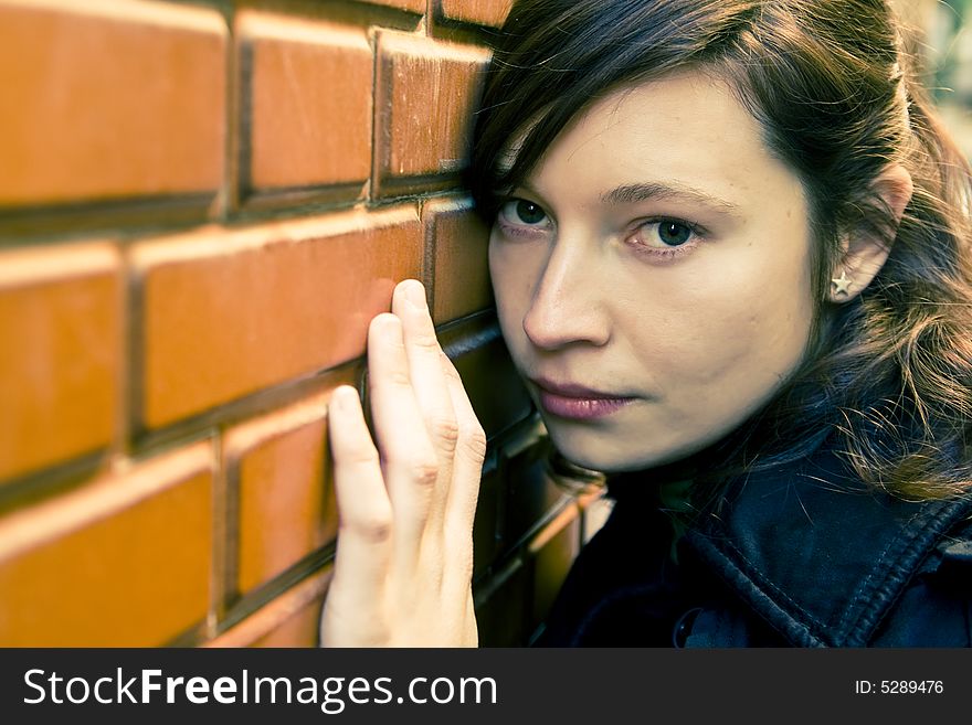 Beautiful girl waiting against brick wall. Beautiful girl waiting against brick wall