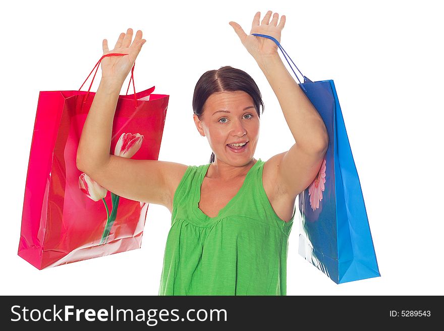 Attractive brunette woman with shopping bags on white background