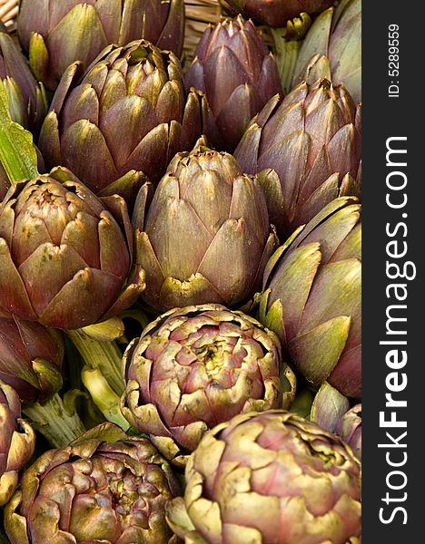 Display of artichokes for sale in a market.