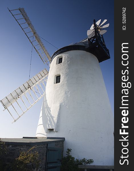 A windmill against a deep blue sky. A windmill against a deep blue sky