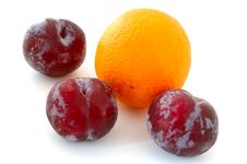 Plums And Orange. Stock Images Plums And Orange. Stock Images