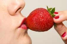 Kissing A Strawberry Stock Photo