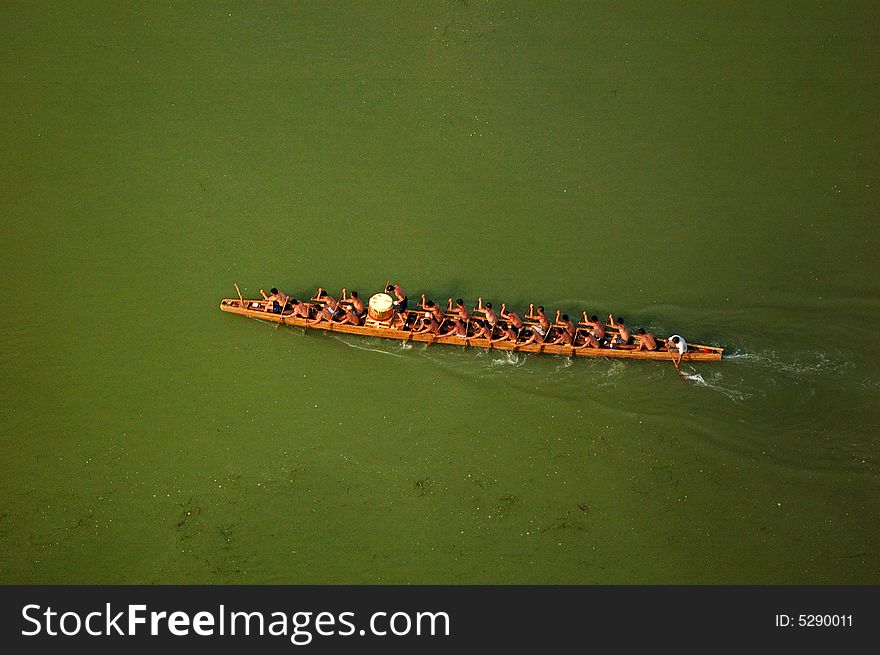 Local people rowing traditional dragon boat on memory of Qv Yuan, the great poet in War-State of China. Local people rowing traditional dragon boat on memory of Qv Yuan, the great poet in War-State of China.