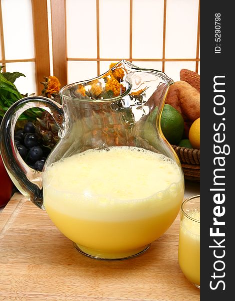 Pitcher of frosty lemon dairy drink in kitchen or restaurant. Pitcher of frosty lemon dairy drink in kitchen or restaurant.