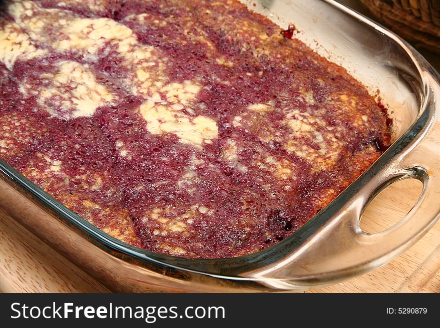 Dark cherry bread pudding close up in baking dish.