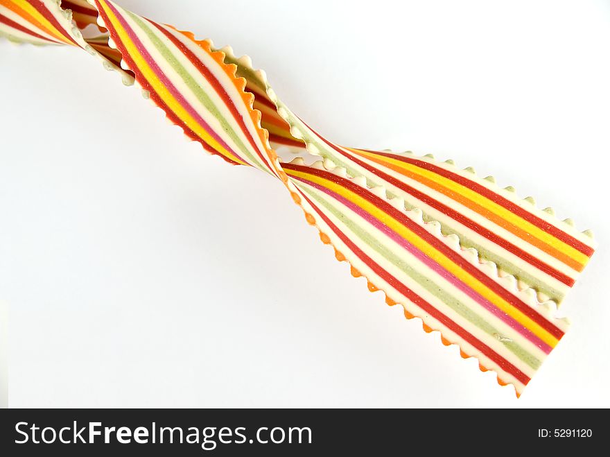 Colorful striped Italian pasta on white