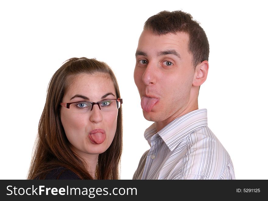 Attractive young couple playfully poking out their tongues - on white. Attractive young couple playfully poking out their tongues - on white