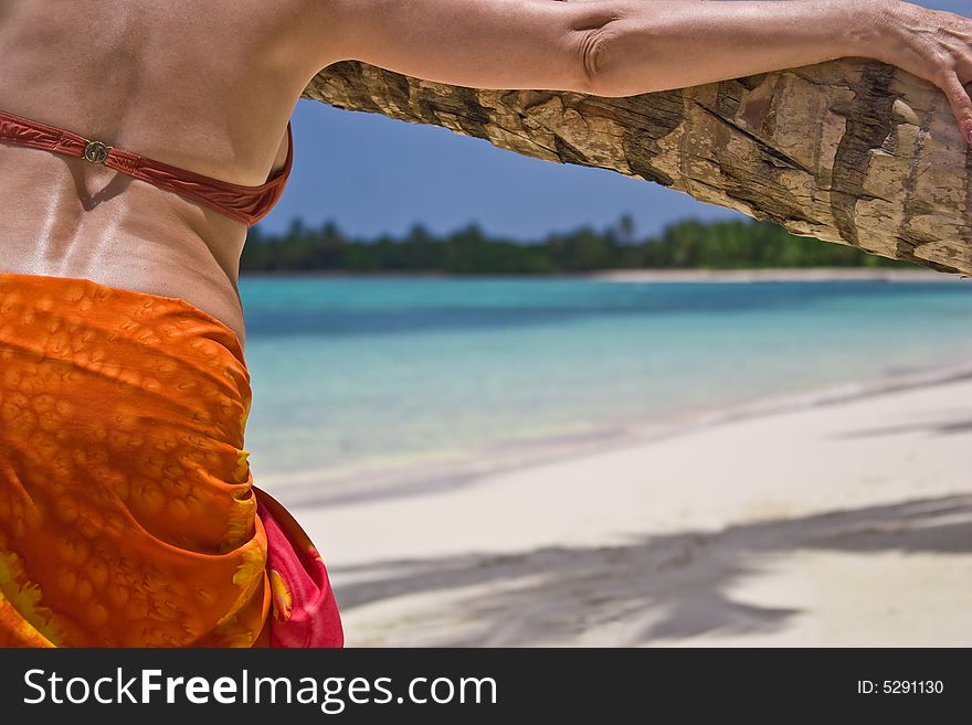 Girl and palm tree on the Bavaro Beach, Dominican republic