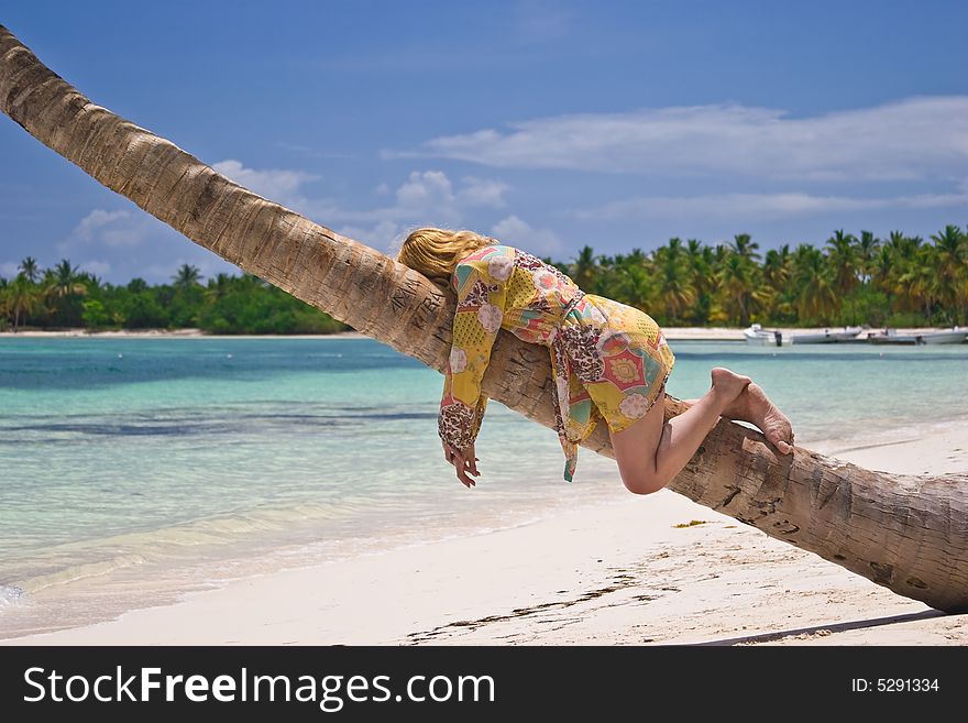 Girl and palm tree on the Bavaro Beach, Dominican republic